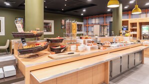 A buffet setup with various food items and serving utensils. -  easyHotel Nice Old Town (Nice)