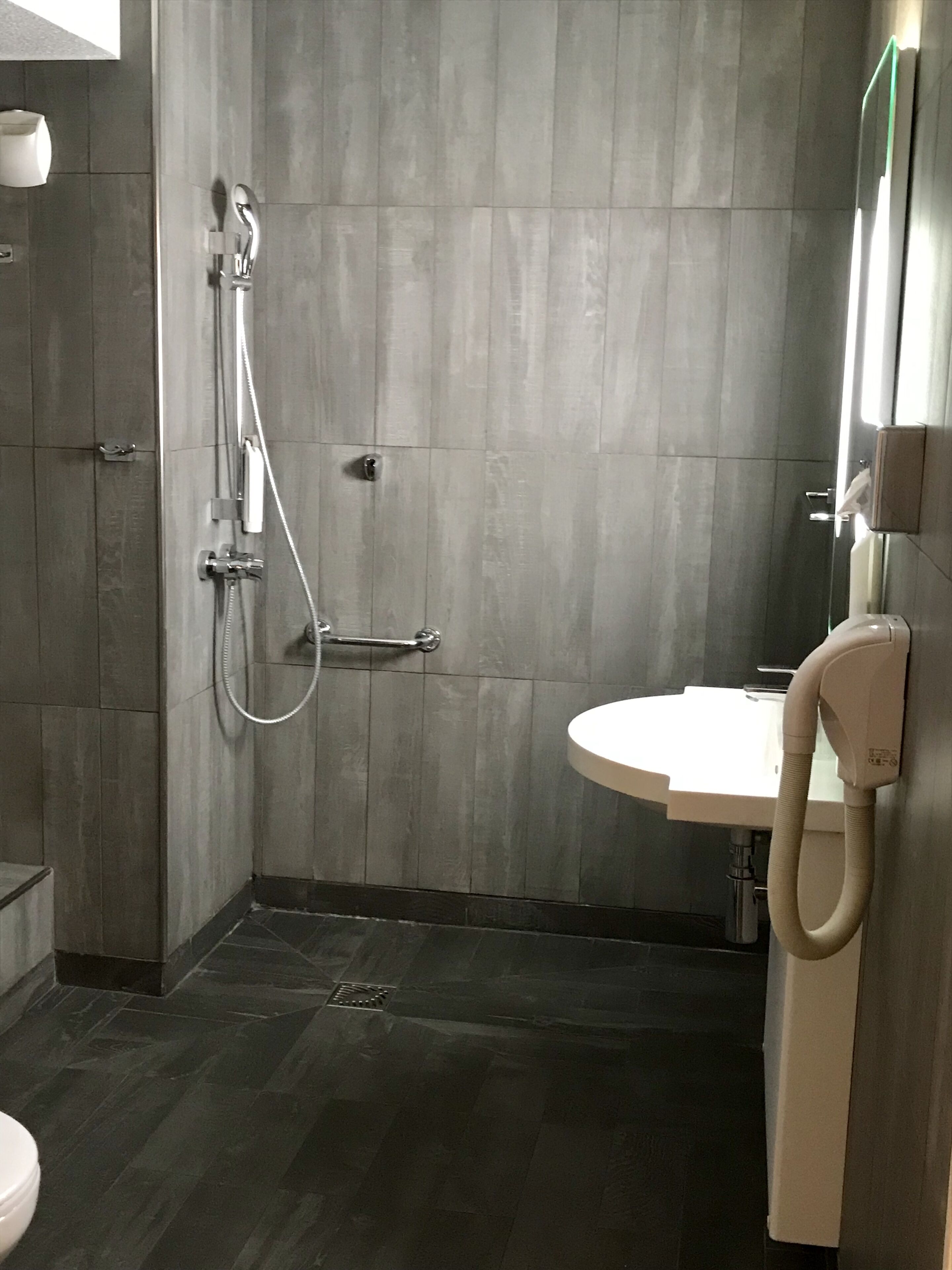 accessible family room with bunkbed and shower | bathroom | towels, toilet paper