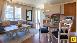 A spacious living room with a dining area, a kitchen, and a balcony with a view of the city. - Unit 613 Cape Royale Apartments (Cape Town)