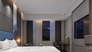 A modern hotel room with a large bed, a desk, and a view of the city at night. - Naive S Hotel (Shenzhen)