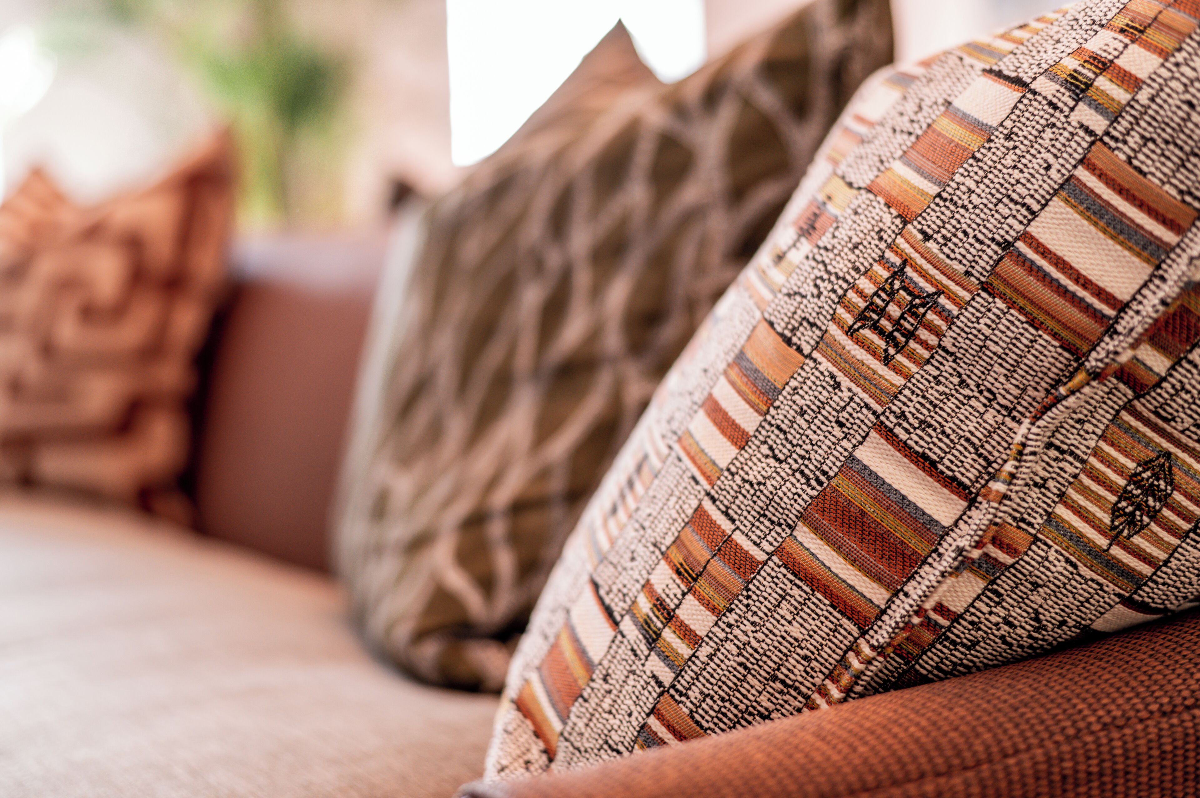 A close-up of a sofa with patterned cushions.