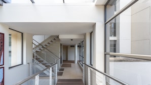 A modern interior with a glass railing, a staircase, and a clean, minimalist design. - 308 Juliette on the Waterfront Marina (Cape Town)