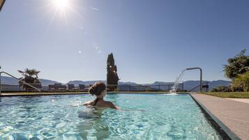 Piscine couverte, piscine extérieure, parasols de plage, chaises longues