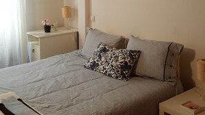 A neatly arranged bedroom with a bed, bedside tables, and a wall-mounted picture. - Beautiful duplex in unbeatable location (Segovia)