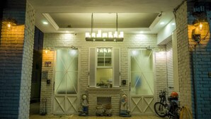 A room with a fireplace, a bicycle, and a motorcycle. - Hualien Bird's House Hostel (Hualien City)
