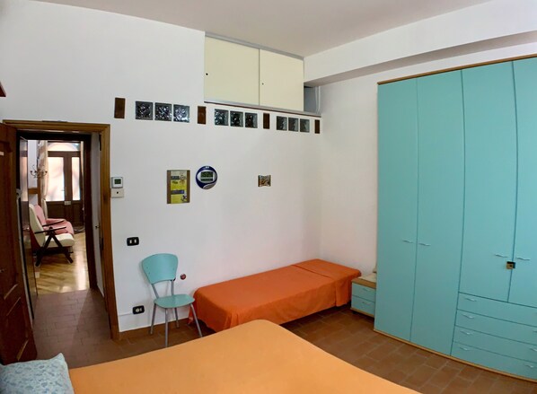 A bedroom with a bed, a chair, a wardrobe, and a wall clock. - Bed & Breakfast in the center of Rionero In Vulture (Rionero In Vulture)