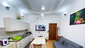 A compact living space with a kitchenette, a dining area, and a sofa. - Bed & Breakfast in the center of Rionero In Vulture (Rionero In Vulture)