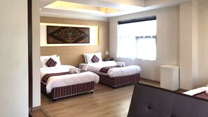 A hotel room with two beds, a large window, and a ceiling light fixture. - ViaVia boutique hotel - Kathmandu (Kathmandu)