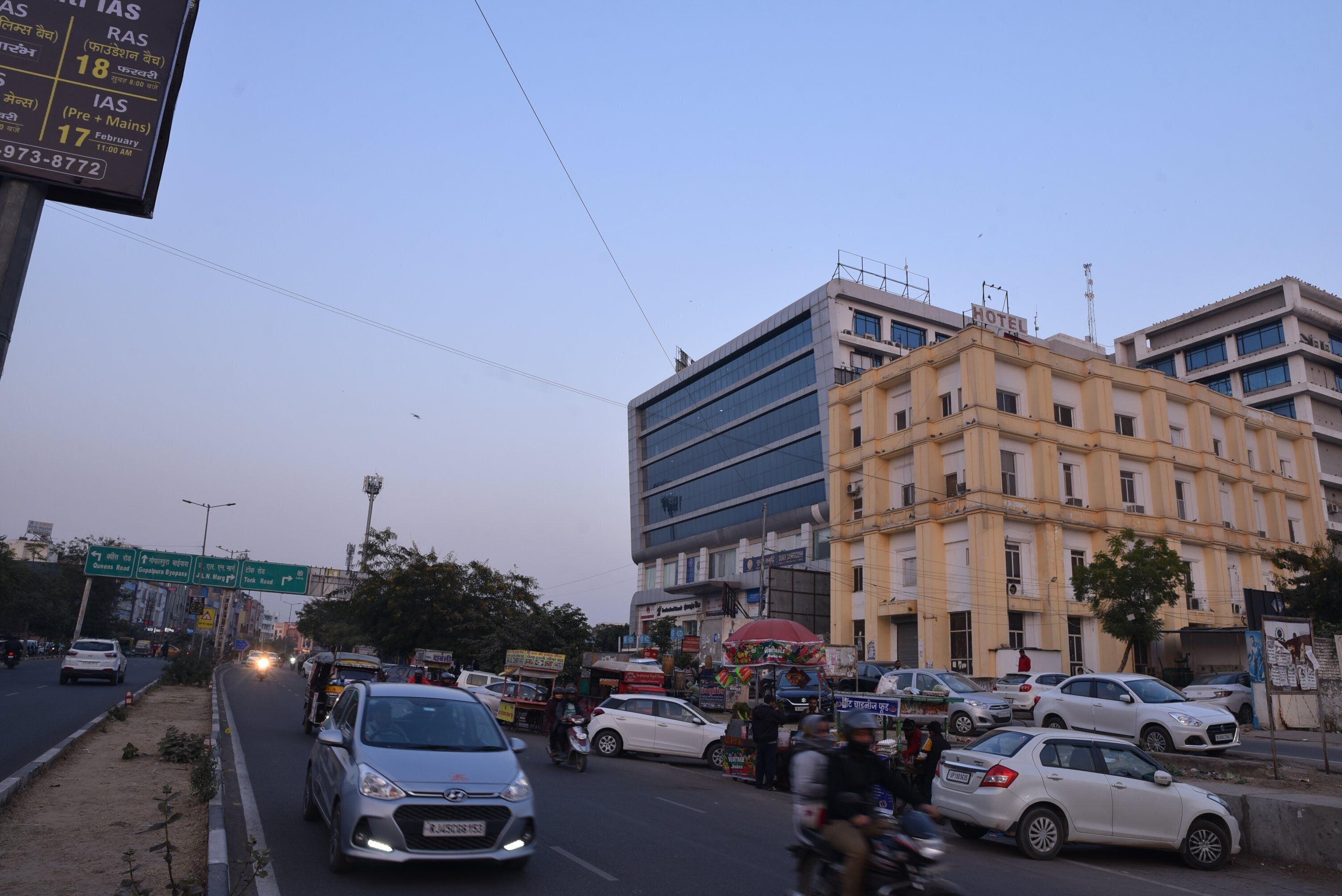 A multi-story hotel with a modern facade, located on a busy urban street.