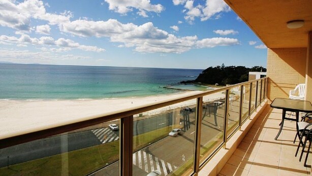 A balcony with a view of a beach and ocean. - Ebbtide Unit 33 (Forster)