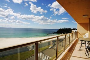 A balcony with a view of a beach and ocean. - Ebbtide Unit 33 (Forster)