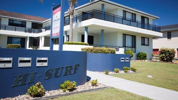 A modern building with a sign reading "HI-SURF" in front. - Hi Surf Unit 4 (Forster)