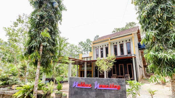 A two-story building with a sign reading "Nabhan Homestay". - Nabhan Homestay (Kalirejo)