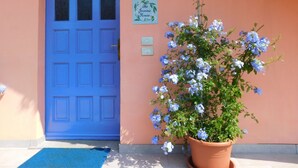 A blue door with a sign reading "The Jasmin House" and a potted plant with blue flowers. - A Country House near the Lake Cod. 012104-CNI-00006 IT012104C24MJ5EPRC (Monvalle)