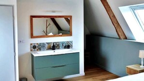 A bedroom with a sloped ceiling, a bed, a bedside table, a mirror, and a built-in cabinet. - Great Ancient Renovated with fireplace and billiards (isigny sur mer)