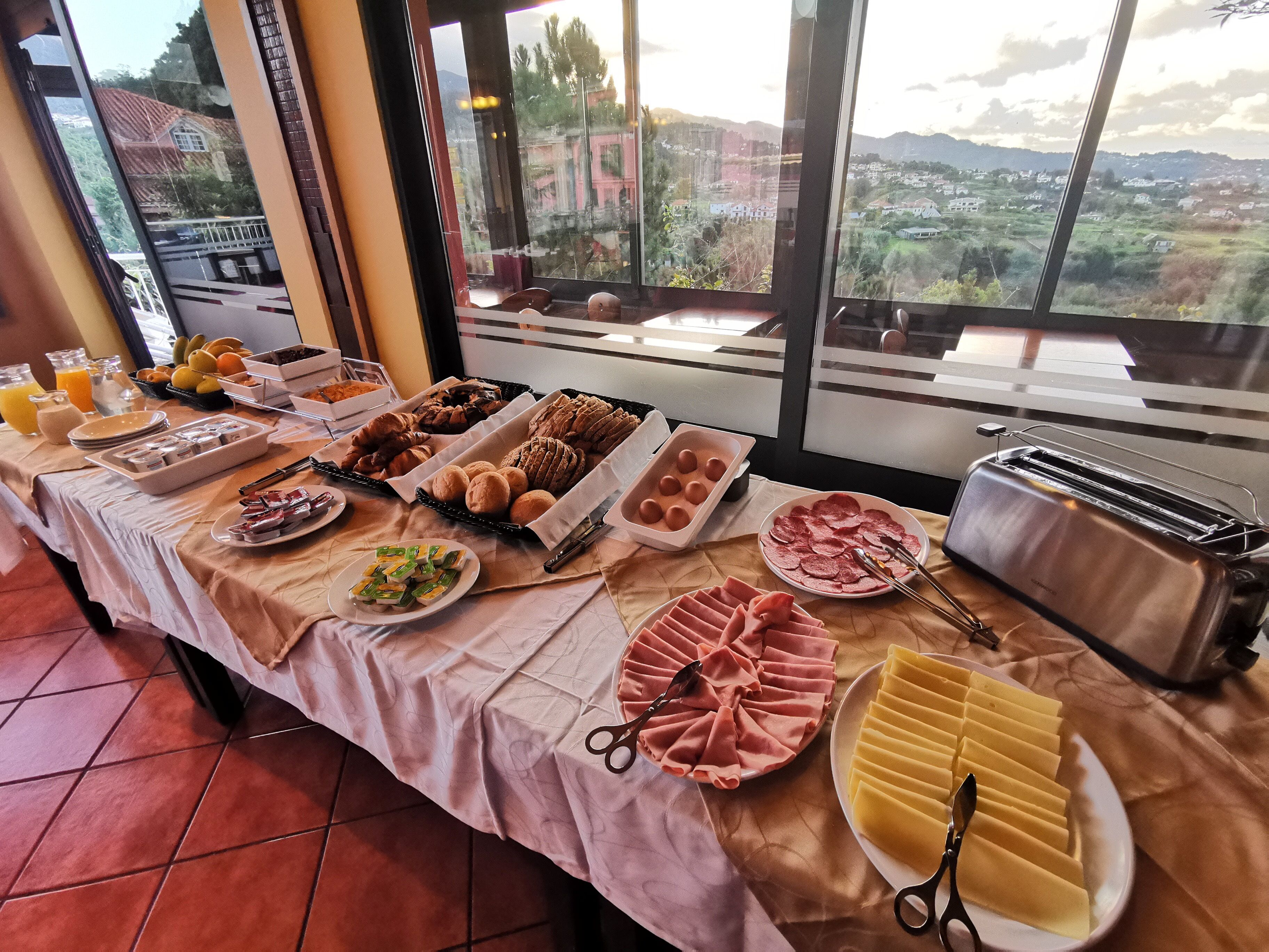 A buffet table with various food items and a toaster.