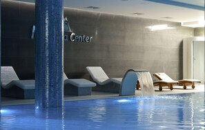 A pool area with lounge chairs and a water feature. - NB Hotel&Spa (Tetovo)