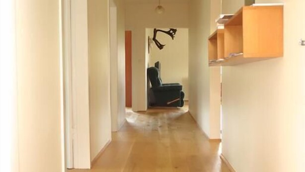 A hallway with wooden flooring, white walls, and a ceiling light fixture. - Thorbrandsstadir Farm Holidays (Vopnafjordur)