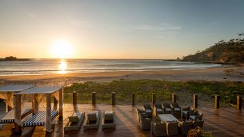 On the beach, sun-loungers