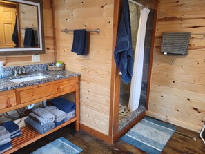 Bathtub, hair dryer, towels, toilet paper