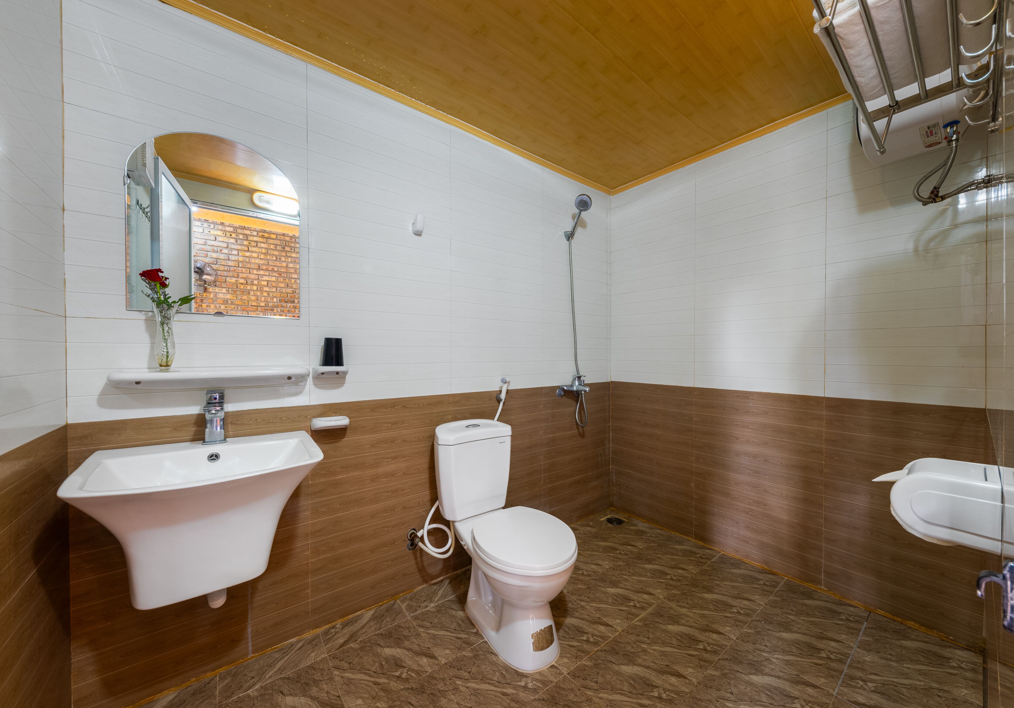 A bathroom with a white sink, a toilet, and a shower.