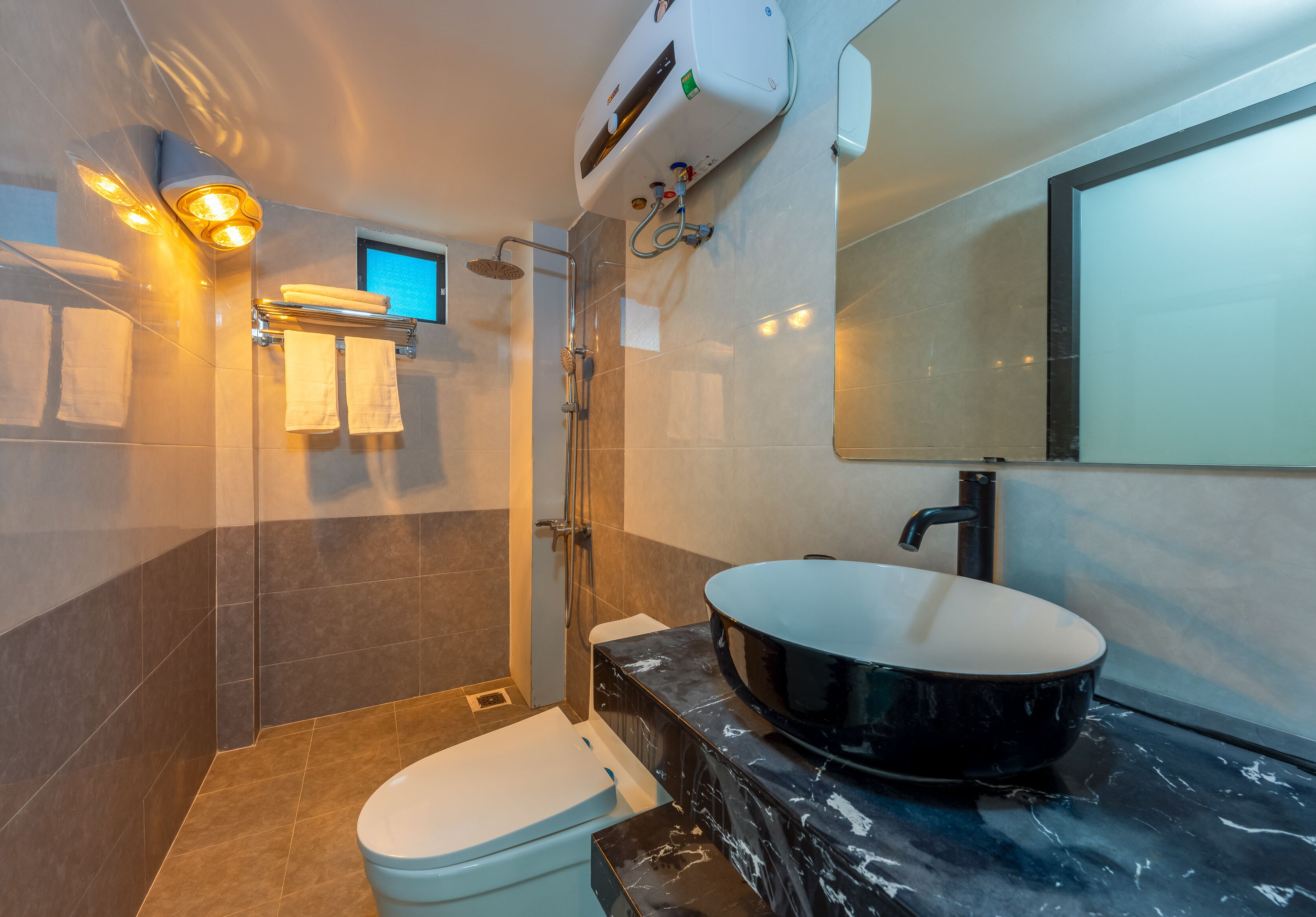 A modern bathroom with a bathtub, toilet, and shower.