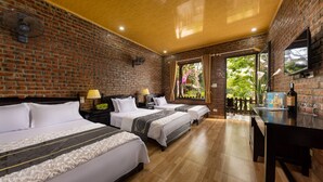 A hotel room with three beds, brick walls, a wooden ceiling, and a view of greenery outside. - Green Homestay (Hai Phong)