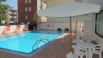 Seasonal outdoor pool, open 9:30 AM to 6:30 PM, pool loungers