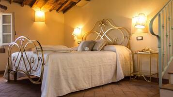 A bedroom with a double bed, two bedside tables, and a lamp on each side.