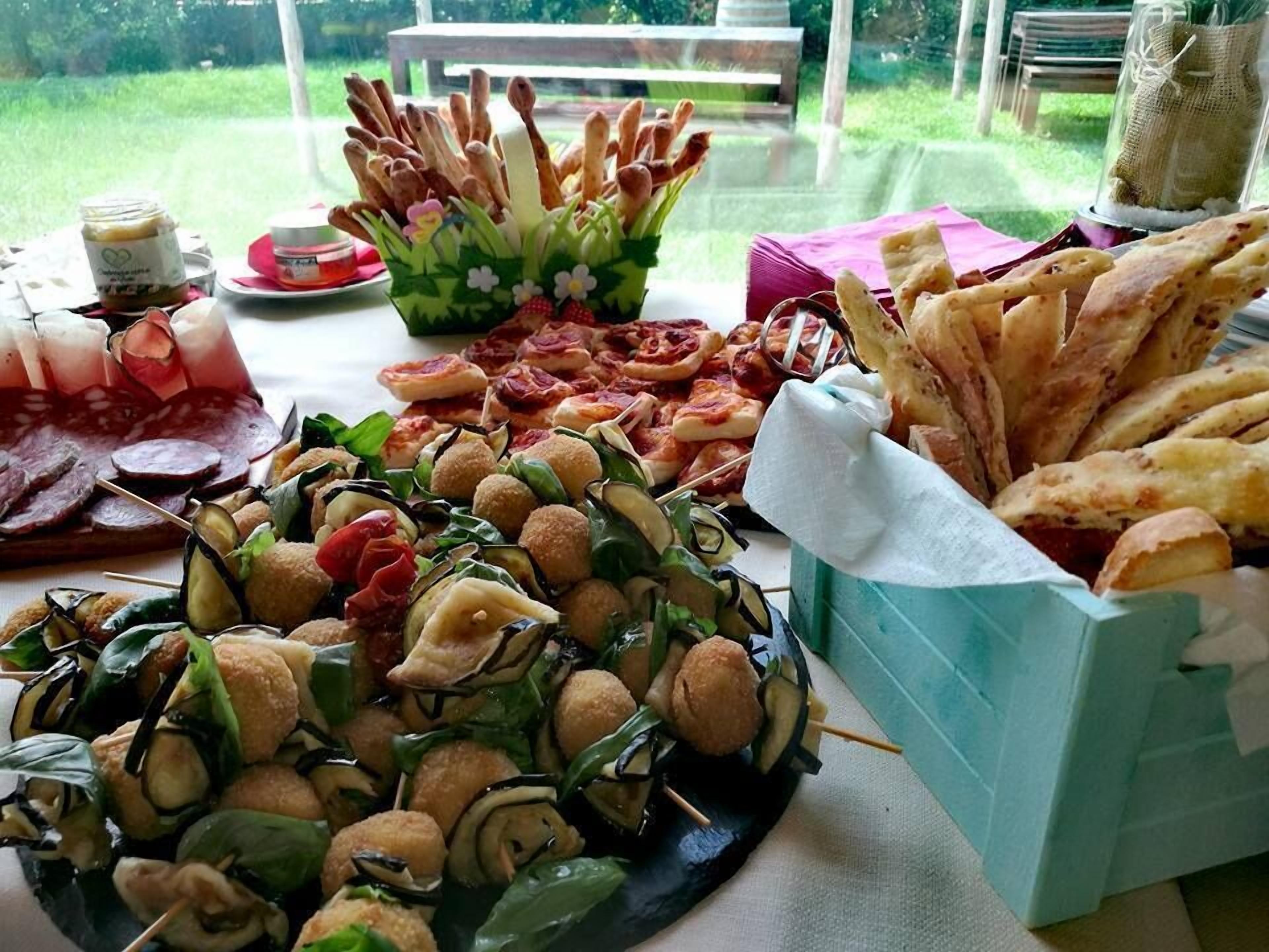 A table with various food items including skewers, bread, and a charcuterie board.