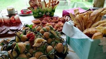 A table with various food items including skewers, bread, and a charcuterie board.