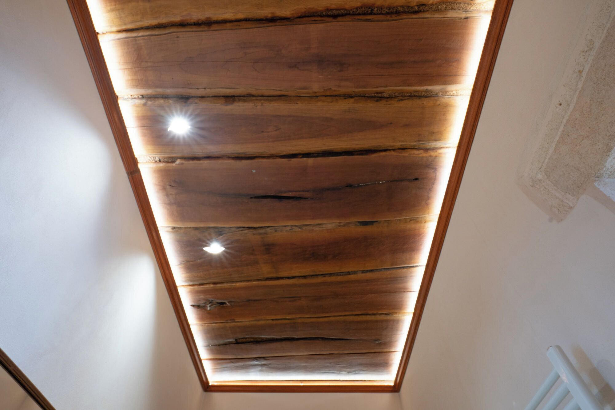 A skylight with wooden slats and a visible light fixture.