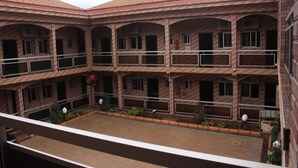A multi-story building with a courtyard. The building has multiple balconies and windows. - Hotel Exelle-Xior (Yaoundé)
