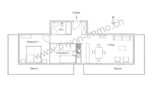 A floor plan of a hotel with two bedrooms, a living room, a balcony, and a WC.