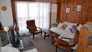 A cozy living room with a sofa, two armchairs, a coffee table, and a television. - The Le Panorama building is located on the 1800 level of the Collons resort. Ideally located, it is (Thyon-Les Collons)