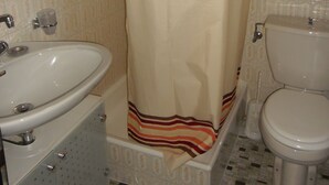 A bathroom with a sink, toilet, and shower curtain. - Nice studio for rent in les Collons (Thyon-Les Collons)