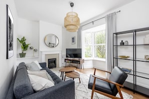 Deluxe Townhome | Living area | Flat-screen TV