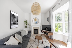 Deluxe Townhome | Living area | Flat-screen TV