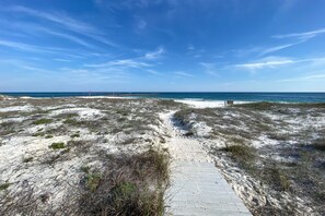 A sandy beach with a wooden boardwalk leading to the ocean. - Gulf Front with Balcony- Perdido Pass-Affordable (Orange Beach)