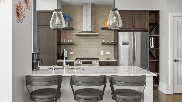 A modern kitchen with a central island, pendant lights, and a built-in stove. - Endless Sunset Retreat | Arras Vacation Rentals (Asheville)