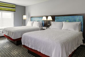 A hotel room with two beds, a nightstand, a lamp, and a window with a view. - Hampton Inn & Suites Pittsburgh New Stanton (New Stanton)