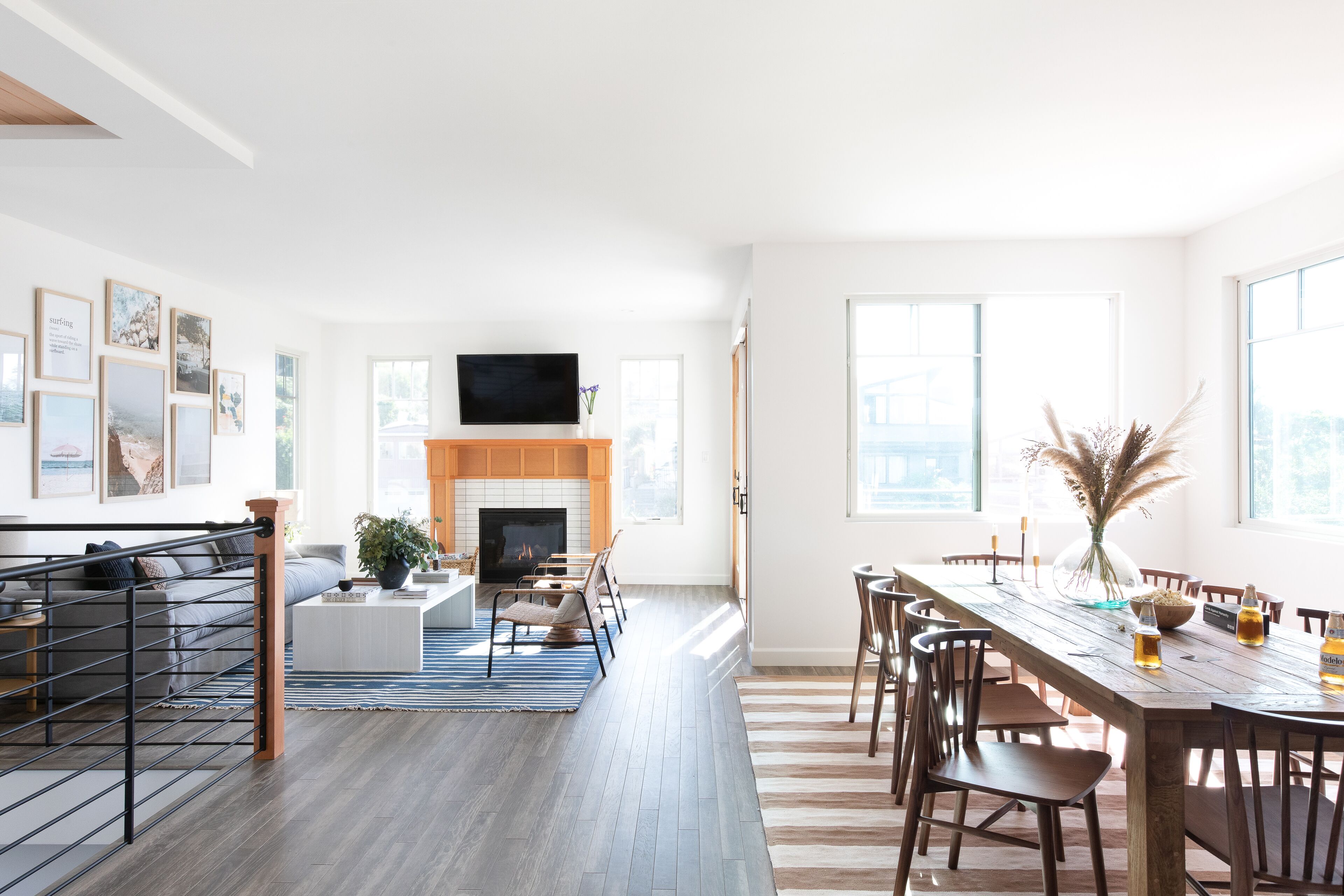 A spacious living area with a fireplace, a dining table, and a TV mounted on the wall.