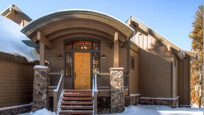 A wooden house with a stone entrance, a wooden door, and a staircase leading up to the front door. - Riverwood Retreat-4BR Warrior's Mark Home, Private Hot Tub, Fireplace, Sleeps 12 (Breckenridge)