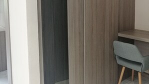 A room with a wooden wardrobe, a desk, and a chair. - Nikis place a nice place to be relax at the riviera maya (Playacar)