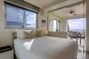 Relax in a spacious room with a large bed, ocean views, and a seating area for dining or unwinding.