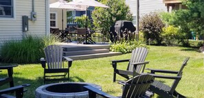 Relax and socialize in this inviting outdoor space with Adirondack chairs and a fire pit.
