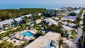 A resort with multiple buildings, a swimming pool, and a tennis court. - Welcome to Paradise! (Key Largo)