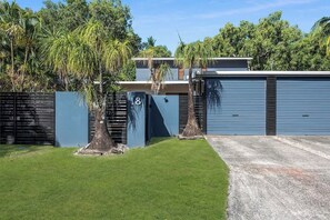 A residential property with a garage, a number 18 garage door, and a well-maintained lawn.