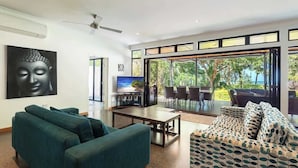 A modern living room with a sofa, coffee table, and a television.