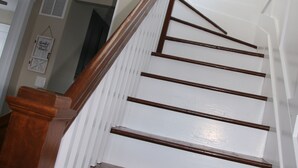 A wooden staircase with white walls and a ceiling light. - Gray's Landing- NEWLY Renovated / 1.8 miles to the ARK! (Williamstown)